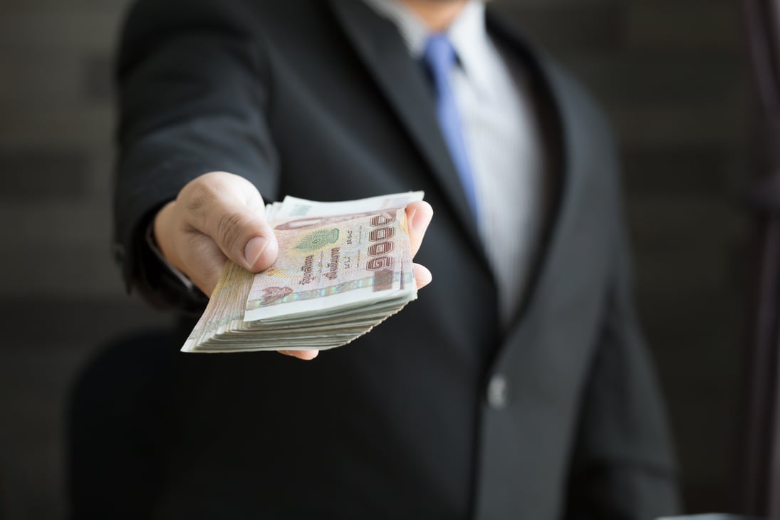 Businessperson Holding a Bunch of Thai Baht